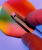 Stock Photo titled: Silicon Wafer And Integrated Circuit Chip, USE OF THIS IMAGE WITHOUT PERMISSION IS PROHIBITED